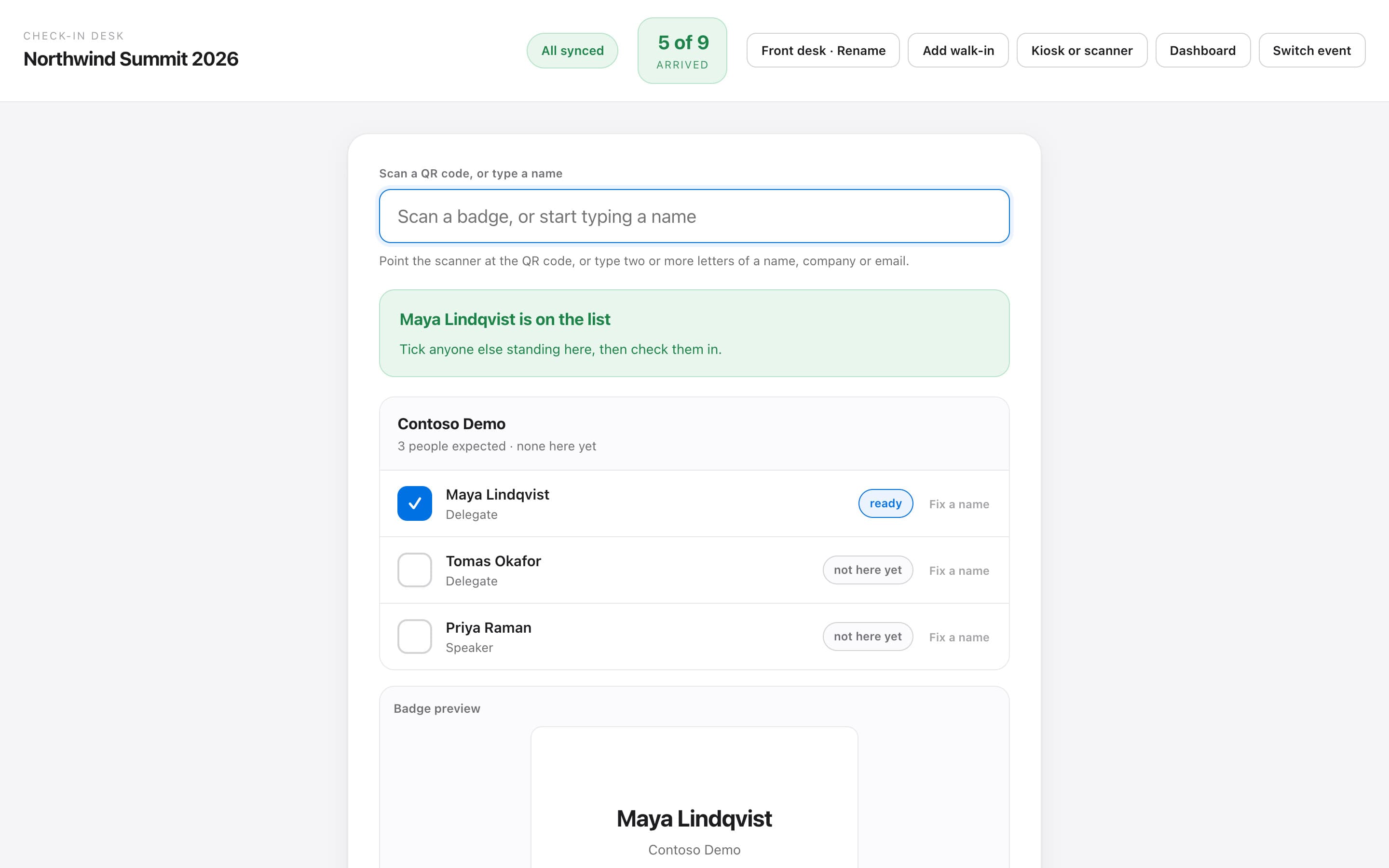 CueDeck check-in desk: one search brings up three guests from the same company, ready to check in together